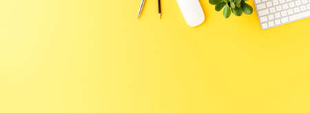 Elegant workspace with business accessories on yellow background with copyspace. Office desktop. Bannerの写真素材