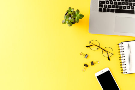 Business background with accessories on yellow table. Office desktop. Top viewの写真素材