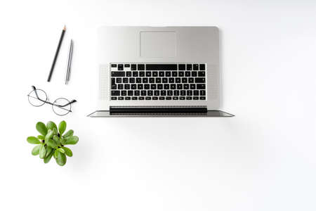 Modern workspace with laptop and accessories on white table. Office desktop concept. Top viewの写真素材
