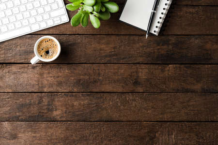 Office desktop with accessories and coffee cup on wooden background. Top viewの写真素材