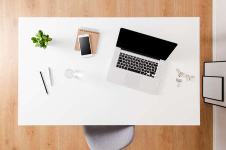 Modern office desktop with laptop and accessoriesの写真素材