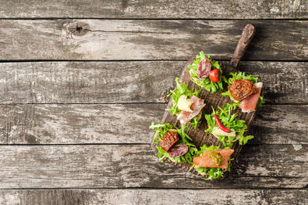 Delicious small sandwiches on wooden boardの写真素材