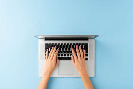Woman's hands working on laptop. Business background with copyspace. Top viewの写真素材