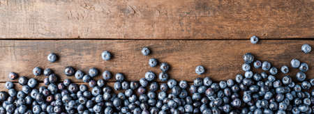 Fresh blueberries on wooden table. Panoramic banner. Top viewの写真素材