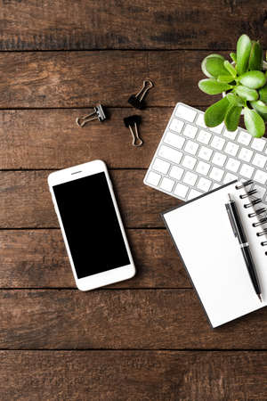 Smart phone with empty screen and business accessories. Office desktopの写真素材