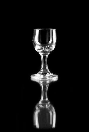 Empty designer glass of vodka isolated on black backgroundの写真素材