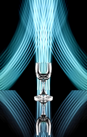 Glass of alcohol on disco background, party atmosphere