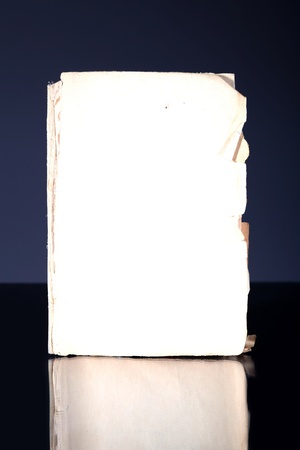 Old book page, vintage object reflected in dark surfaceの写真素材