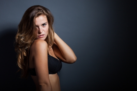 Portrait of sexy natural woman in lingerie on dark backgroundの写真素材