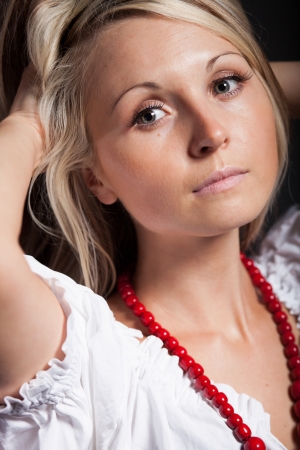 Folk woman in folklore clothes from Europe braiding a plaitの写真素材