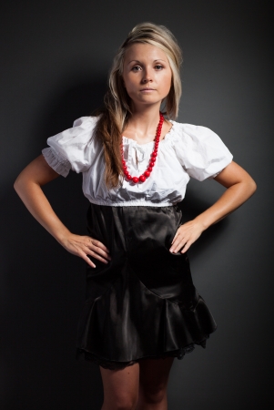 Folk woman in folklore clothes from Europe braiding a plaitの写真素材