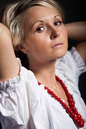 Folk woman in folklore clothes from Europe braiding a plaitの写真素材