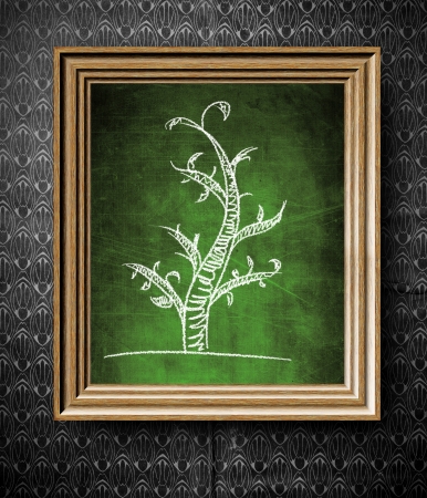Geneological family tree chalkboard in old wooden frame on vintage wallの写真素材