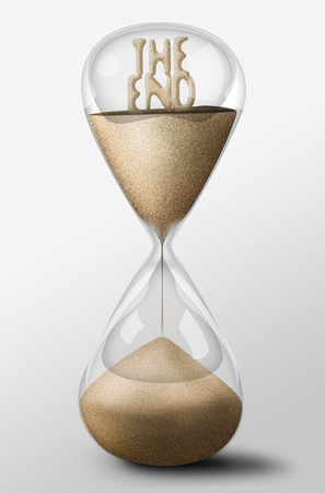 Hourglass with The End word made of sand inside the clock. Concept of passing timeの写真素材
