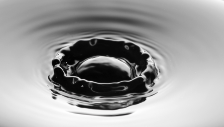 Water splash close up with ripples, clean grey backgroundの写真素材