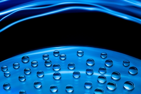 Abstract music background, colorful water drops on CD/DVD discの写真素材