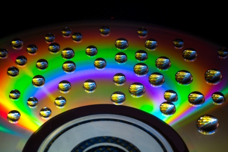 Abstract music background, colorful water drops on CD/DVD discの写真素材