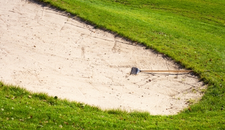 Sand bunker on golf course with rakeの写真素材