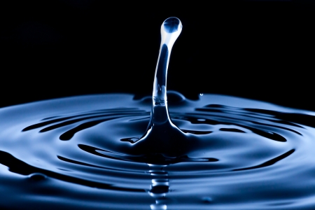 Water splash and drop, dark blue background