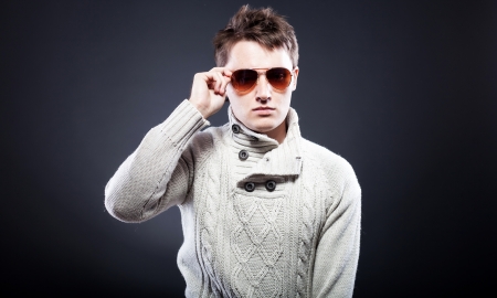 Young man in white sweater and sunglassesの写真素材