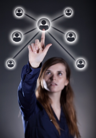 Woman's hand pushing social media button on touch screenの写真素材