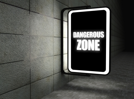 Dangerous zone warning sign at night on streetの写真素材