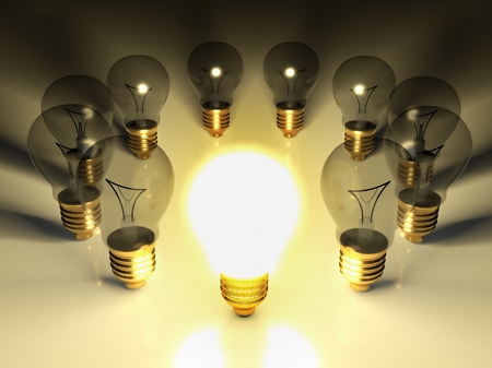 One glowing light bulb amongst other light bulbs, concept of ideaの写真素材