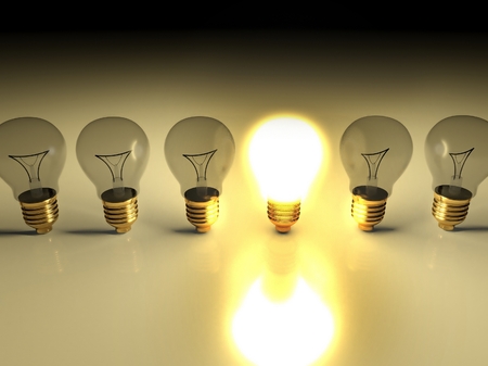 One glowing light bulb amongst other light bulbs, concept of ideaの写真素材