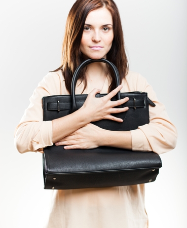 Elegant young woman with black leather bagの写真素材