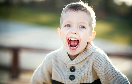 Screaming child, portrait of little boy playing
