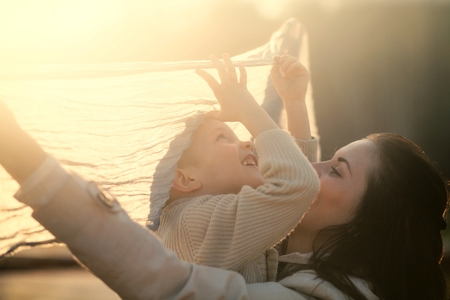 Mother and child playing in the park outdoorの写真素材
