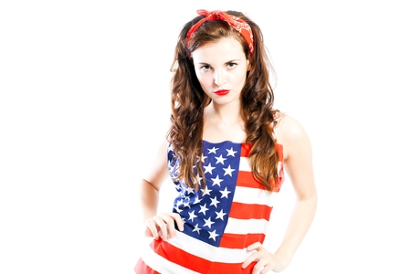 Pin up girl wrapped in american flag, isolated whiteの写真素材