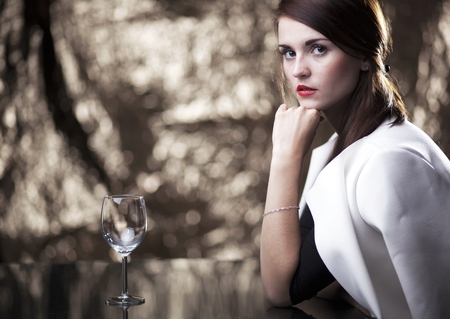 Glamour woman sitting alone in luxury restaurantの写真素材