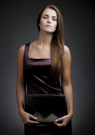 Elegant beautiful woman with clutch bagの写真素材