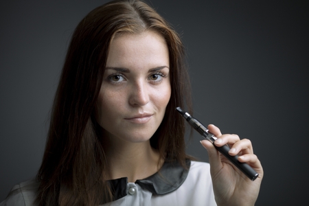 Elegant beautiful woman with e-cigaretteの写真素材