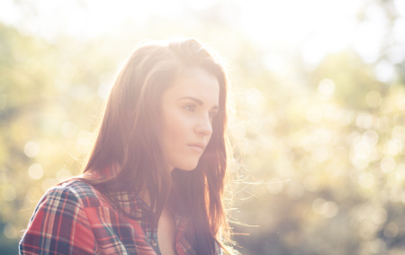 Young woman outdoor portrait in soft sunny daylight