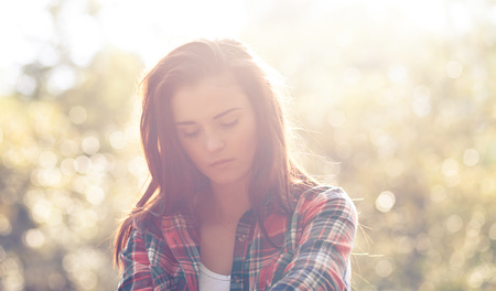 Young woman outdoor portrait in soft sunny daylight