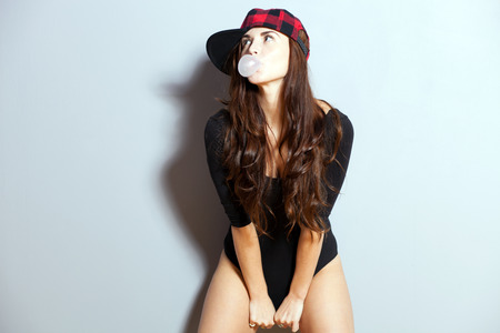 Closeup fashion studio portrait of hipster young womanの写真素材