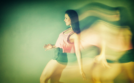 Modern hip hop dancer woman in motion blurの写真素材