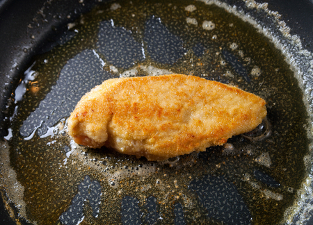 Chicken breast fillets fried in frying pan with butterの写真素材