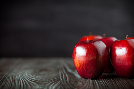 Red apples on wooden table dark background, copy spaceの写真素材