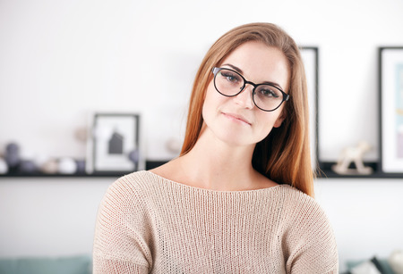 Young beautiful woman with eyeglasses at her home