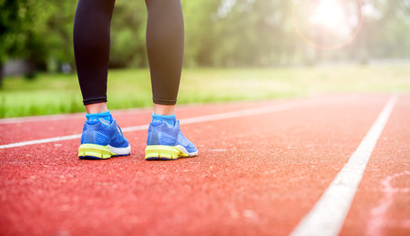 Athletic woman feet on running track, close up on shoe