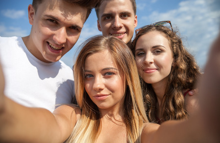 Selfie of group of teenage friends city outdoorの写真素材