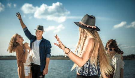 Group of friends dancing and celebrating on beach, boho party outdoorの写真素材