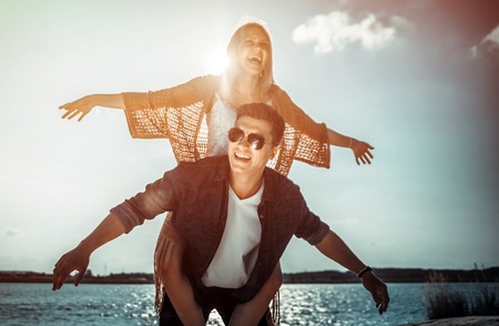 Happy couple having fun outdoor at sunset, love and friendship conceptの写真素材