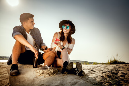 Happy couple outdoors, fashion styled friends have funの写真素材