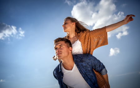 Happy couple having fun outdoor at sunset, love and friendship conceptの写真素材