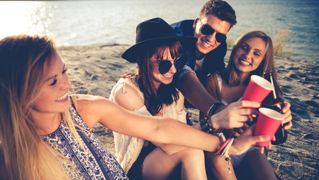 Friends having fun and enjoying beach festival party, youth concept