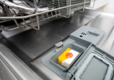 Detergent tablet in dishwasher machine, close upの写真素材